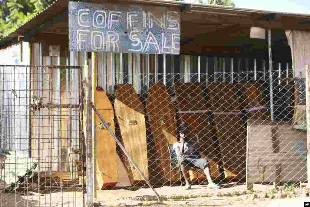 A worker at a coffin making company waits for clients in Harare as Zimbabwe has began a 30-day lockdown in a bid to rein in the spike in COVID -19 infections threatening to overwhelm health services.