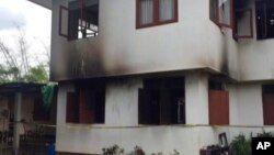 In this image made from video, the outside of a damaged school dormitory is seen where local police say 18 girls, ranging from five to 12 years old, died in a fire in Chiang Rai province, northern Thailand, May 23, 2016.