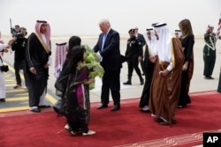 President Donald Trump and first lady Melania Trump are greeted by King Salman shortly after arriving at the Royal Terminal of King Khalid International Airport, May 20, 2017, in Riyadh.