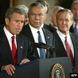 President Bush with Secretary of State Colin Powell and Secretary of Defense Donald Rumsfeld. The president spoke to reporters before signing a congressional resolution for the use of force against Iraq.