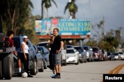 Local residents wait for the reopening of the entry road for the Florida Keys road after Hurricane Irma strikes Florida, in Homestead, Florida, Sept. 11, 2017.