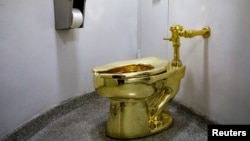Maurizio Cattelan’s “America,” a fully functional solid gold toilet is seen at The Guggenheim Museum in New York City, U.S., August 30, 2017. 