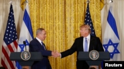 U.S. President Donald Trump (R) greets Israeli Prime Minister Benjamin Netanyahu 