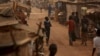 FILE - A boy walks in a camp sheltering internally displaced people next to the M'Poko international airport in Bangui, Central African Republic, Feb. 13, 2016.