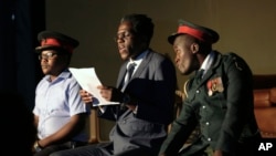 In this photo taken March, 28, 2018, actor Khetani Banda, playing former Zimbabwean president Robert Mugabe, center, reads a speech flanked by army generals during a play dramatizing the events leading to his resignation, in Harare, Zimbabwe.