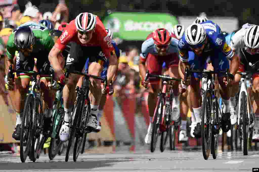 Colombia's Fernando Gaviria (C) sprints in the last meters to cross the finish line ahead of Slovakia's Peter Sagan (L) and Germany's Andre Greipel (2ndL) to win the fourth stage of the 105th edition of the Tour de France cycling race between La Baule and Sarzeau, western France.