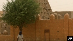 A man walks past the Sankore Mosque, a UNESCO World Heritage Site, in Timbuktu, Mali, April 11, 2012.