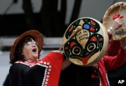 Sharon Brown, a Haida tribal member from Bonney Lake, Wash., drums during a march for Indigenous Peoples Day, Oct. 12, 2015, in Seattle. As the U.S. observes Columbus Day, it will also be Indigenous Peoples Day in some U.S. cities.