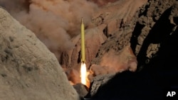 In this photo obtained from the Iranian Fars News Agency, a surface-to-surface missile is fired by Iran's Revolutionary Guard, during a maneuver, at an undisclosed location in Iran, March 9, 2016. Iran says it fired similar missiles into eastern Syria Sunday.