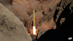 In this photo obtained from the Iranian Fars News Agency, a Qadr H long-range ballistic surface-to-surface missile is fired by Iran's Revolutionary Guard, during a maneuver, in an undisclosed location in Iran, Wednesday, March 9, 2016.