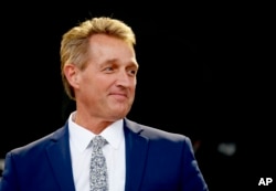Sen. Jeff Flake, R-Ariz., looks on during an appearance at the Forbes 30 Under 30 Summit, Oct. 1, 2018, in Boston.