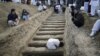 A man prepares graves for the burial of victims of Saturday's bomb attack in a Shi'ite Muslim area, in the Pakistani city of Quetta, February 17, 2013.