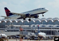 FILE - A Delta Air Lines jet takes off from Ronald Reagan Washington National Airport in Arlington, Va., July 28, 2014.