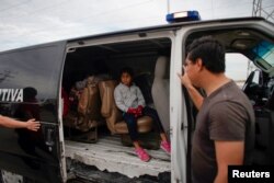 A child leaves a temporary shelter for migrants in a police car, in Piedras Negras, Mexico, Feb. 7, 2019.