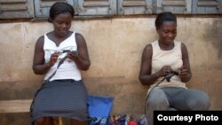 Janet and Mercy, two of the KamiAmi Women, practice their crocheting skills. (Photo by Jackie Abrams)
