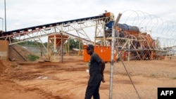 FILE - A security employee guards a diamond-processing plant in the diamond-rich eastern Marange region of Zimbabwe, Dec. 14, 2011 