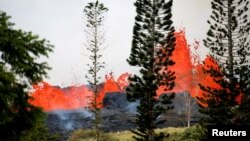 Lava erupts on the outskirts of Pahoa during eruptions of the Kilauea volcano in Hawaii, May 19, 2018. 
