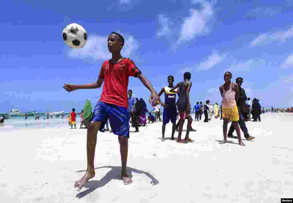 Somali boys play football in Lido beach while celebrating the Muslim Eid al-Fitr holiday, in the capital, Mogadishu, August 8, 2013.&nbsp;