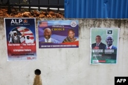 FILE - Picture taken July 31, 2017 in Monrovia shows campaign posters on a wall as the campaign kicks off for the presidency and House of Representatives elections in October.