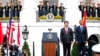 President Barack Obama and Chinese President Xi Jinping stand at attention for the playing of each counties national anthem during an official state arrival ceremony for the Chinese president, Sept. 25, 2015.