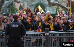 FILE - Pro-independence demonstrators shout during a protest outside the regional parliament in Barcelona, Spain, Jan. 30, 2018.