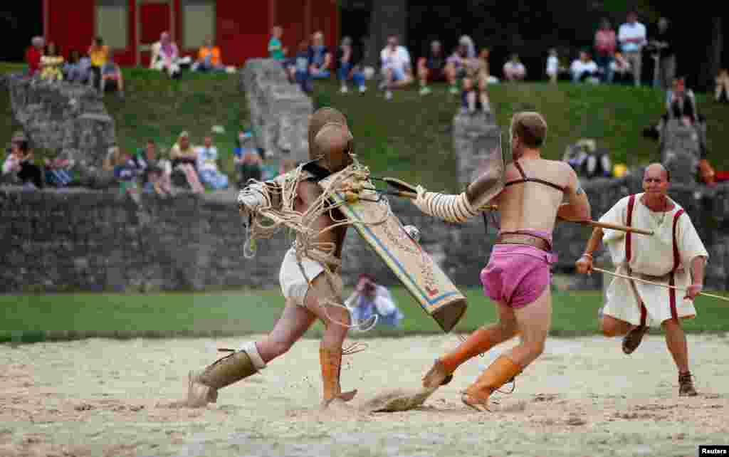 Members of the &quot;Familia Gladiatoria Carnuntina&quot; fight in the historic amphitheatre during the Roman Festival at the archeological site of Carnuntum in Petronell, Austria, June 11, 2016.