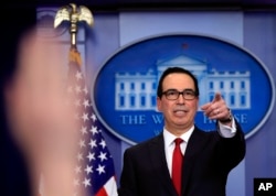 FILE - Treasury Secretary Steven Mnuchin, gestures during a White House daily press briefing in the Brady press briefing room at the White House, in Washington, Jan. 11, 2018.