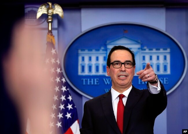 Treasury Secretary Steven Mnuchin, gestures during a White House daily press briefing in the Brady press briefing room at the White House, in Washington, Jan. 11, 2018.