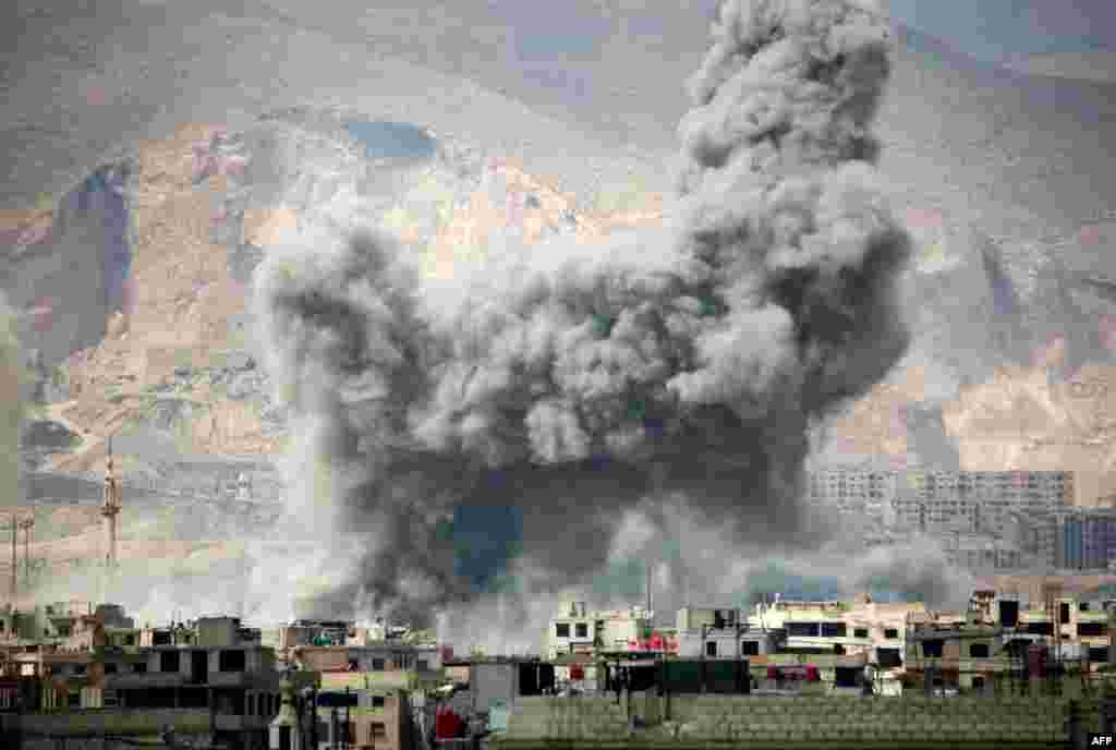 Smoke billows following a reported airstrike in the rebel-held parts of the Jobar district, on the eastern outskirts of the Syrian capital Damascus.