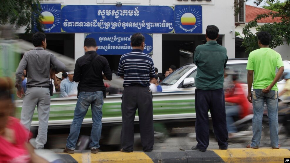 Journalists wait in front of Cambodia National Rescue Party (CNRP) during the party's meeting, in Phnom Penh, Cambodia, Thursday, May 26, 2016. 