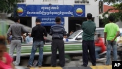 Journalists wait in front of Cambodia National Rescue Party (CNRP) during the party's meeting, in Phnom Penh, Cambodia, Thursday, May 26, 2016. 