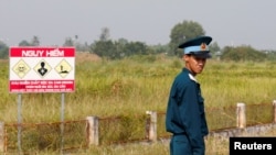 FILE - A Vietnamese soldier stands guard at the dioxin-contaminated area at Bien Hoa airbase, where the U.S. Army stored the defoliant Agent Orange during the Vietnam War, in Bien Hoa city, outside Ho Chi Minh City, Vietnam, October 17, 2018.