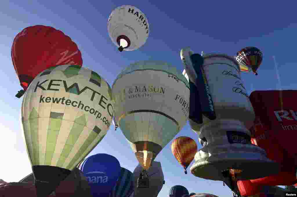 Balloons take off during a mass launch at the Bristol International Balloon Fiesta in south west England. The largest hot air balloon festival in Europe takes place over four days and is in it&#39;s 37th year.