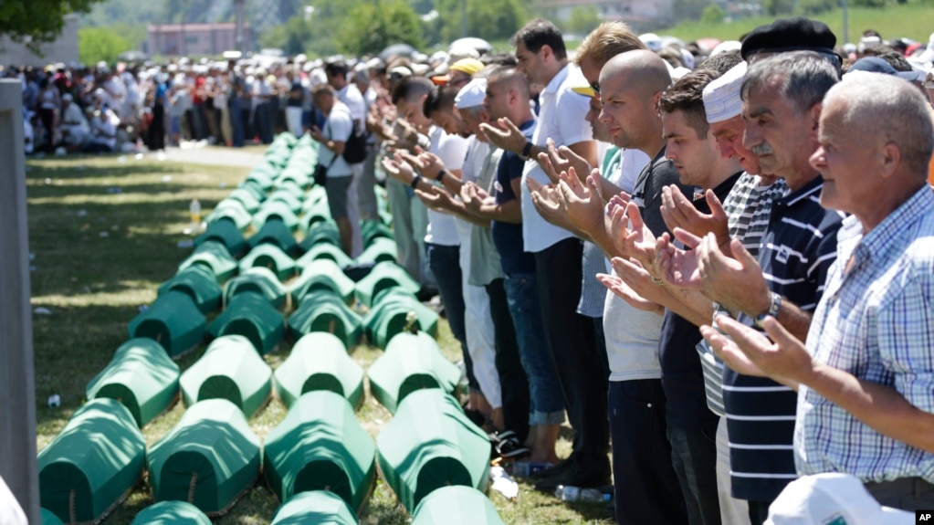 Bosnian Muslims pray in front of coffins during a reburial ceremony for dozens of newly identified victims of the 1995 massacre, at the memorial center of Potocari near Srebrenica, 150 km northeast of Sarajevo, Bosnia, July 11, 2017.