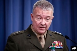 FILE - In this April 14, 2018, photo, then-Marine Lt. Gen. Kenneth "Frank" McKenzie Jr. speaks during a media availability at the Pentagon in Washington. McKenzie, now the top commander of U.S. forces in the Mideast, says Iran appears to have decided to "step back and recalculate" in response to a U.S. military buildup in the Persian Gulf area.