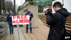 On Dec. 10, 2018, Ada Yu of Vancouver and a man who wished to remain unidentified, hold a sign in favor of the release of Huawei Technologies CFO Meng Wanzhou outside her bail hearing at British Columbia Superior Courts following her Dec. 1 arrest in Canada.