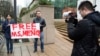 Ada Yu of Vancouver and a man who wished to remain unidentified, hold a sign in favor of the release of Huawei Technologies CFO Meng Wanzhou outside her bail hearing at British Columbia Superior Courts following her Dec. 1 arrest in Canada.