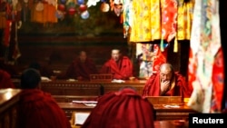 Tibetan monks read scriptures at the Tsurphu Monastery in Doilungdeqen county Tibet