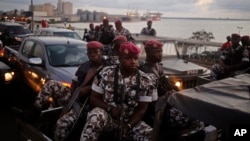 FILE - Ivory Coast troops provide security during an election rally of Ivory Coast incumbent President Alassane Ouattara in Abidjan, Ivory Coast. Some unidentified soldiers launched mutinies in three cities across this West African country Jan. 6, 2017.