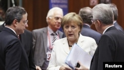 European Central Bank (ECB) President Mario Draghi (L) and Italy's Prime Minister Mario Monti (R) listen to Germany's Chancellor Angela Merkel during a European Union leaders summit in Brussels June 29, 2012.