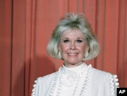 FILE - Actress and animal rights activist Doris Day poses for photos after receiving the Cecil B. DeMille Award she was presented with at the annual Golden Globe Awards ceremony in Los Angeles, Jan. 28, 1989.