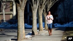 FILE - A students walks through the campus of Nassau Community College Garden City, New York, Feb. 2, 2016. A new study has found that up to 14 percent of U.S. community college students were homeless and that two thirds of students go hungry.