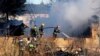 Ministry for Emergency Situations workers and fire fighters work at a site of a fire of a psychiatric hospital, April 26, 2013.