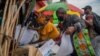 A masked couple shops at an outdoor market near the Baragwanath taxi rank in Soweto, South Africa, Dec. 2, 2021. 