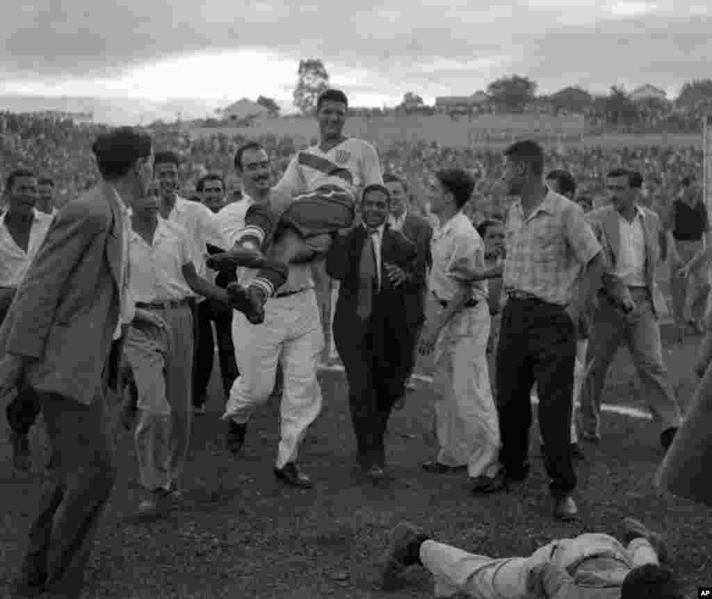 U.S. center forward Joe Gaetjens is carried off by cheering fans after his team beat England 1-0 in the World Cup qualifier match at Belohorizonte, Brazil, June 28, 1950. Gaetjens scored the winning goal in the shock result of the tournament.