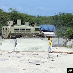An African Union armored personnel carrier enters the heavily-fortified AMISOM headquarters in Mogadishu