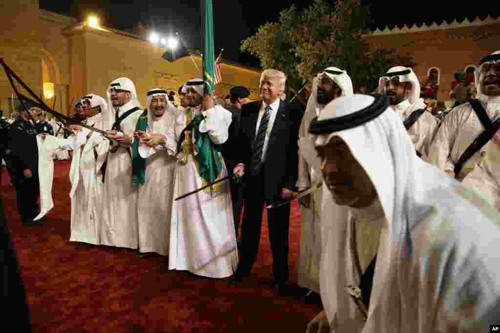 Presiden Donald Trump memegang pedang dan mengayunkannya bersama para penari tradisional Saudi saat upacara penyambutan di Istana Murabba di Riyadh, Arab Saudi, 20 Mei 2017.