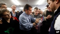 Republican presidential candidate, Sen. Ted Cruz, autographs a sign during a campaign event at the Johnson County Fairgrounds, Jan. 31, 2016 in Iowa City, Iowa.