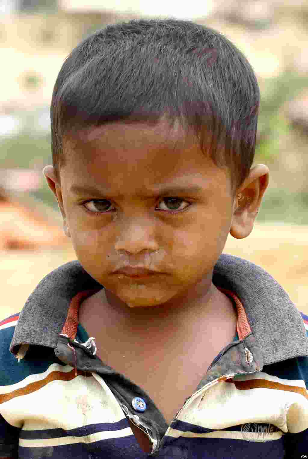 Mohammed Tajon, 2, cries after falling down the stair steps at Kutupalong refugee camp April 1, 2019. (Hai Do/VOA)