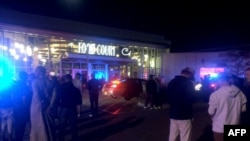 This image from video provided by KSTP 5 television in Minneapolis, Minnesota, shows people standing outside the scene of a stabbing at the Crossroads Center mall in St. Cloud, Minnesota.